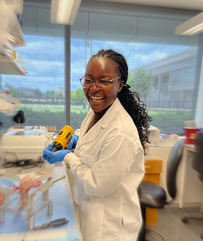 Shola at the lab bench working with bone