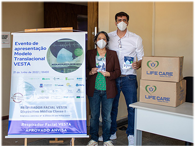 Suelia presents the Vesta face mask technology at a conference with husband, Mario.